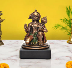 Resin Hanuman idol: seated blessing pose, raised hands, multicolor details.