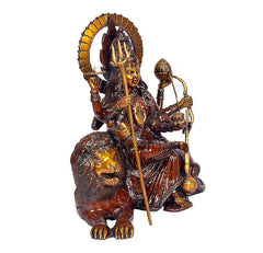 Brass Durga idol with tall circular halo, one hand holding trident, lion at feet