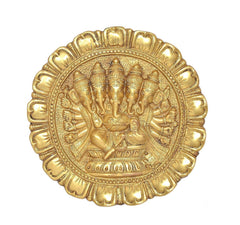 Close-up brass Panchmukhi Ganesha relief in ornate circular border
