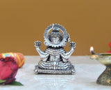 Seated Ganesha idol from behind, detailed halo and beaded lower border.