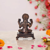 Back view of seated Lakshmi murti with halo and raised hands, copper finish