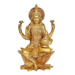 Gold-tone brass Lakshmi statue idol on lotus base, four-armed pose with detailed jewelry
