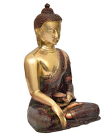 Meditating Buddha idol with closed eyes, brass finish, dark robe, patterned base