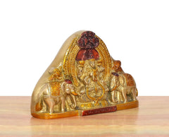 Brass Gaja Lakshmi idol side view with elephant details and ornate halo
