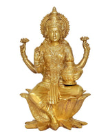Brass Lakshmi goddess statue seated on carved lotus base, gold tone finish