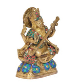 Saraswati goddess statue playing veena, gold finish with multicolour jewel inlays