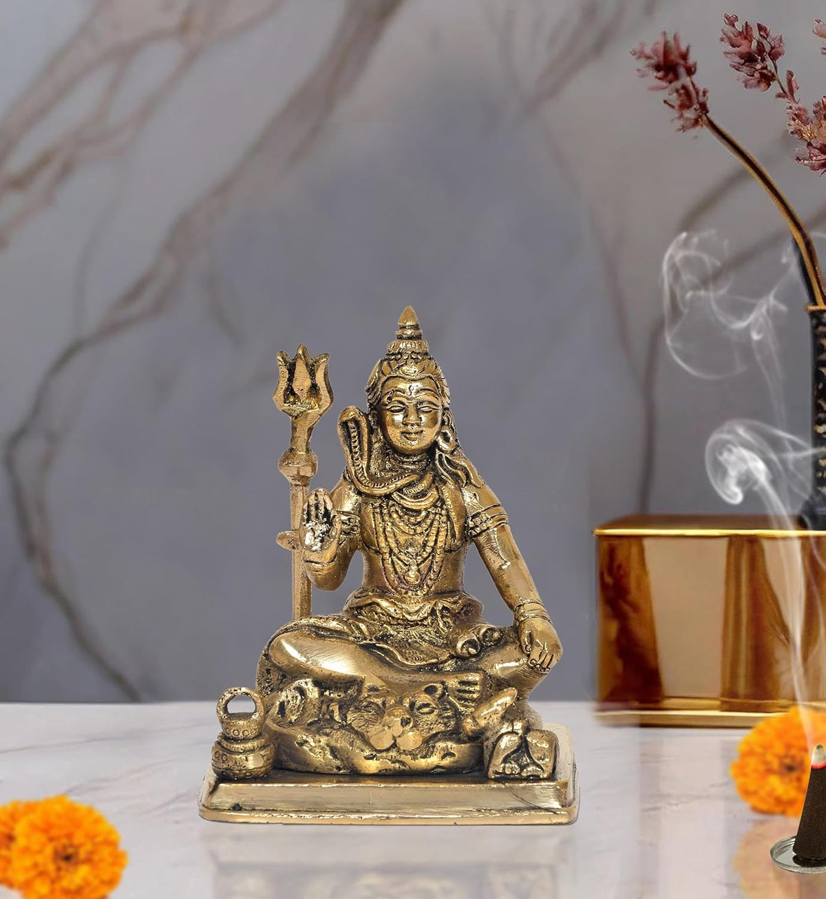 Brass Lord Shiva seated sculpture with raised trident and ornate detailing on base