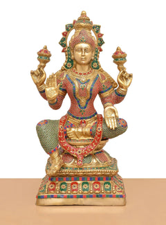 Lakshmi brass idol front view, raised hands and lotus-seated body with jeweled details