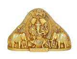 Brass Ganesha idol with detailed relief, seated figure under ornate arch, gold finish