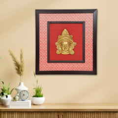 Brass Maa Durga face idol wall hanging in dark wooden frame with red backing