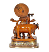 Brass cow figurine with Krishna behind it, rear view on round base