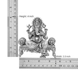 4 inch height, 3.5 inch width brass seated Ganesha idol shown with measuring scale