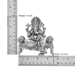 4 inch height, 3.5 inch width brass seated Ganesha idol shown with measuring scale
