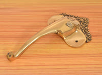 Golden brass Ganesha face door handle lever with decorative crown detail