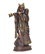 Brass Radha Krishna idol statue three-quarter view, flute gesture, ornate golden trim