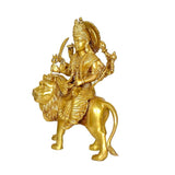 Side view brass Durga statue on lion, detailed ornaments and weapons