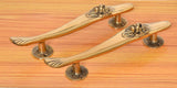 Brass gold door pull handles pair with curved profiles and lion-face end details