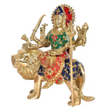 Durga Maa figure on lion, red crown with blue jewels, holding trident and flame-like staff