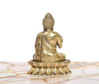 Brass Buddha idol from back view, seated on lotus base, textured crown