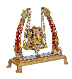 Brass Ganesha jhula showpiece angled view, red jeweled pillars with gold chains