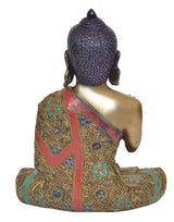 Back view meditating Buddha statue, ornate robe inlay with blue, green and red gems
