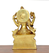 Brass Saraswati statue, rear view with round headgear and raised ornaments