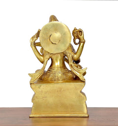 Brass Saraswati statue, rear view with round headgear and raised ornaments
