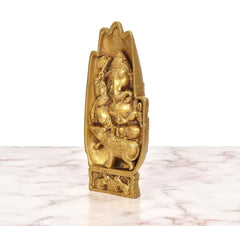 Golden brass Ganesha idol angled view showing seated form, mouse base, and relief details.