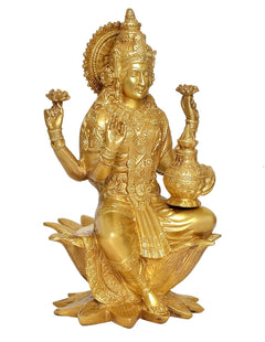 Brass Lakshmi statue holding a pot, seated on lotus petals with ornate patterns