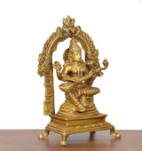 Three-quarter brass Saraswati goddess idol with raised hands, arched halo, veena