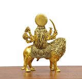 Durga Maa brass idol on lion from rear, crown, trident, and weapons visible