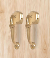 Golden brass Ganesha face door handle pair, matching curved handles