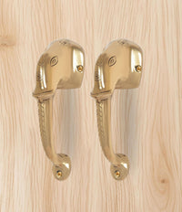 Golden brass Ganesha face door handle pair, matching curved handles
