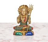 Seated Shiva figurine in brass with trident, jeweled turquoise, red, and blue accents