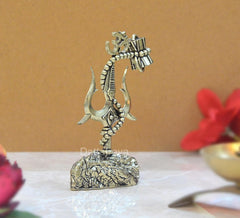Brass Lord Shiva trishul and damru showpiece from a side angle