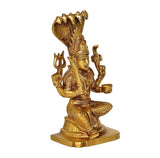 Gold brass Durga Mariamman idol angled view, four arms raised, seated on rectangular base