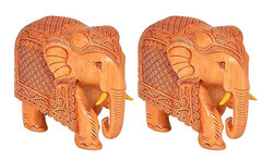 Two tan carved wooden elephants, front/side view, ornate detailing