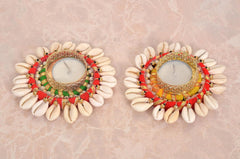 Two Diwali tea light holders: green-red and orange-red bead trim, gold mesh centers, shells