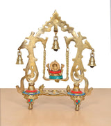 Brass Ganesha swing idol rear view with gold-tone back arch, bell holders, tripod base
