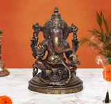 Brass Ganpati Bappa murti with four-armed seated figure, ornate crown and jewelry