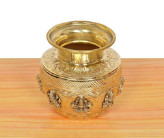 Gold-toned brass kalash with carved floral bands and Ashtalakshmi medallion