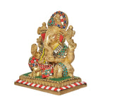 Brass Ganesha idol in profile, jeweled crown, colorful torso details, striped base