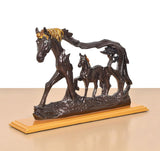 Resin horse figurine with foal, dark brown bodies and gold-toned mane on pedestal.