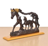 Resin horse figurine with foal, dark brown bodies and gold-toned mane on pedestal.