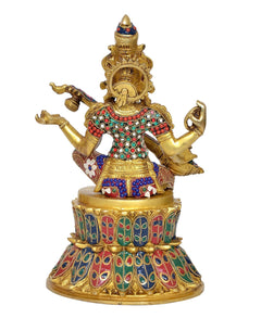 Brass Saraswati idol with circular back ornament, seated on lotus pedestal, veena pose