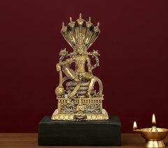 Panchaloha Vishnu idol seated with multi-hood canopy and ornate gold-tone base