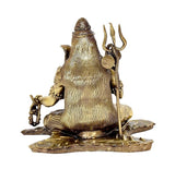 Rear view of gold-tone Lord Shiva brass sculpture with trident staff on base