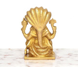 Brass Narasimha statue back view, textured shoulder scales and gold finish
