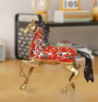 Brass running horse showpiece with red body, gold accents, and black mane