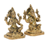 Brass Lakshmi and Ganesh idols, close side view, textured crowns and raised arms
